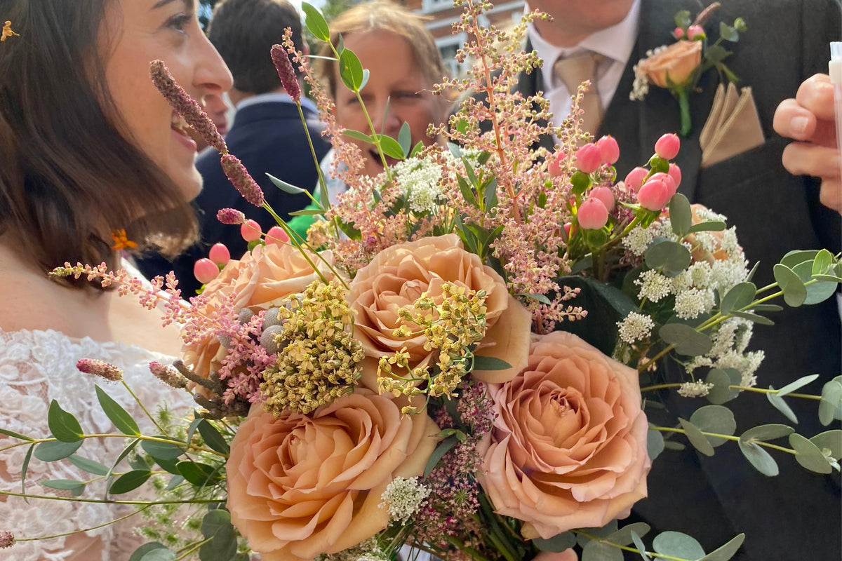 Bouquet of flowers created by Treloen Flowers held by a person with a blurred background